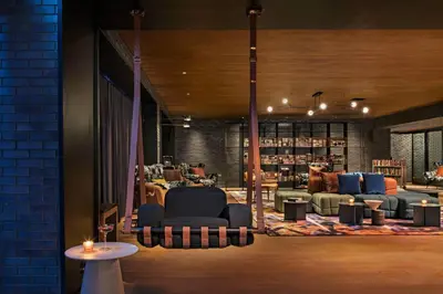 a library with couches and chairs in a room at Moxy NYC East Village in New York