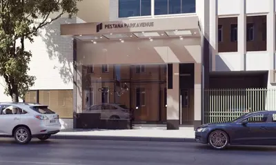 two cars parked in front of a building at Pestana Park Avenue in New York