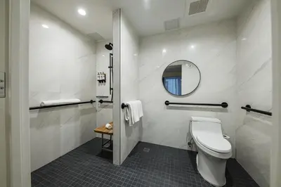 a bathroom with a toilet and a mirror at Pestana Park Avenue in New York