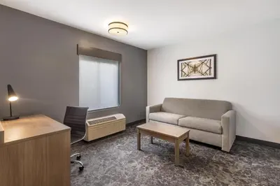 a living room with a couch and a chair at Best Western Manchester in Manchester