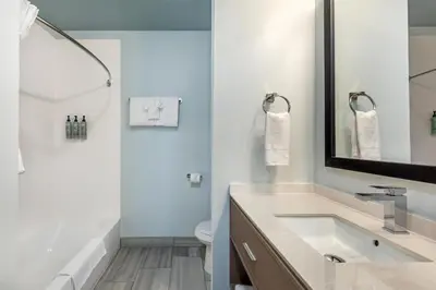 a bathroom with a sink and a tub and a toilet at Best Western Manchester in Manchester