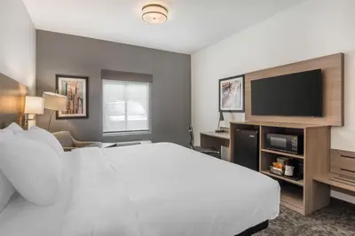 a hotel room with a bed and a flat screen tv at Best Western Manchester in Manchester