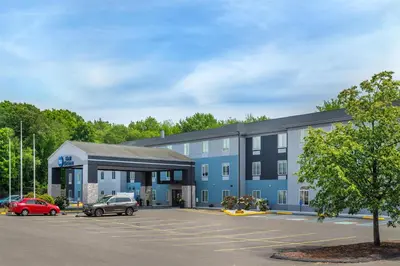 a blue building with cars parked in a parking lot at Best Western Manchester in Manchester
