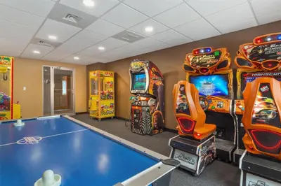 a gaming room with arcade games and a bowling alley at Best Western Manchester in Manchester