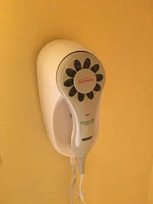 a hair dryer is hanging on a wall at Days Inn by Wyndham Scranton PA in Dickson City