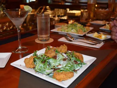 a table with plates of food and a drink at Deerfield Inn in Deerfield