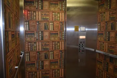 a room with a wall full of books at Deerfield Inn in Deerfield