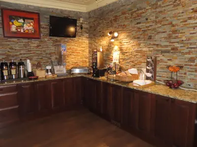 a bar in a room with a brick wall at St Charles Hotel Downtown Hudson in Hudson