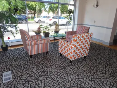 two chairs and a coffee table in a room at St Charles Hotel Downtown Hudson in Hudson