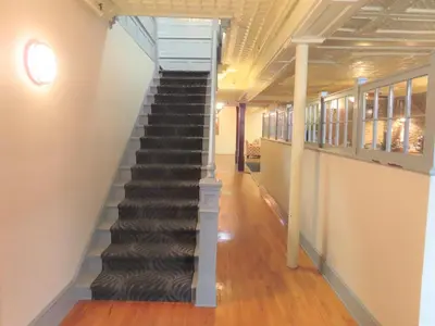 a spiral staircase in a building with a hallway at St Charles Hotel Downtown Hudson in Hudson