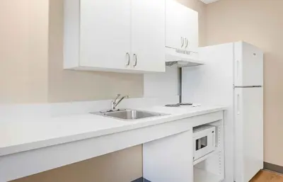 a white kitchen with a sink and a microwave at Extended Stay America Suites - Hartford - Farmington in Farmington