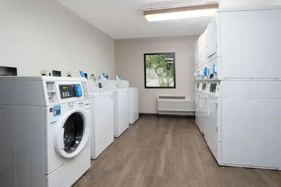 a laundry room with white washers and dryers at Extended Stay America Suites - Hartford - Farmington in Farmington
