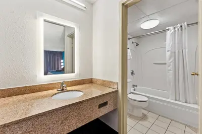 a bathroom with a sink and a toilet at Howard Johnson by Wyndham Albany in Albany