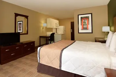 a hotel room with a bed and a television at Extended Stay America Select Suites - Hartford - Manchester in Manchester