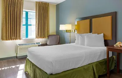 a hotel room with a large bed and a window at Extended Stay America Select Suites - Hartford - Manchester in Manchester