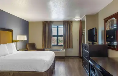 a hotel room with a bed and a flat screen tv at Extended Stay America Suites - Hartford - Meriden in Meriden