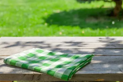 a green and white napkin sitting on a wooden table at Extended Stay America Suites - Hartford - Meriden in Meriden