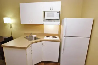 a kitchen with a white refrigerator and a sink at Extended Stay America Suites - Hartford - Meriden in Meriden