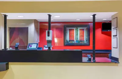 a lobby with red walls and a desk with a laptop at Extended Stay America Suites - Hartford - Meriden in Meriden