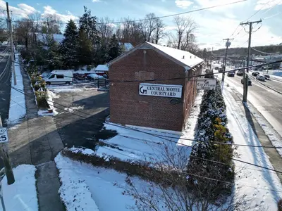 a sign on a brick building in the snow at Central Motel Courtyard in White Plains