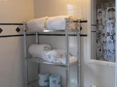a towel rack in a bathroom with towels at Central Motel Courtyard in White Plains