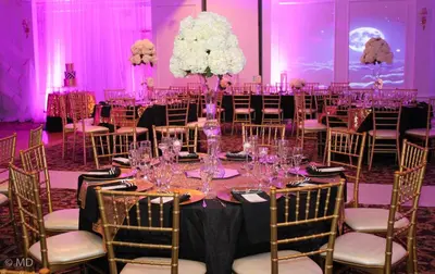 a ballroom with a table with wine glasses at Hotel NoMa, Trademark Collection by Wyndham in New Rochelle
