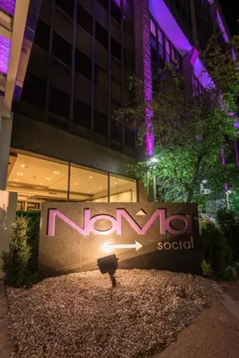 a sign in front of a building at night at Hotel NoMa, Trademark Collection by Wyndham in New Rochelle