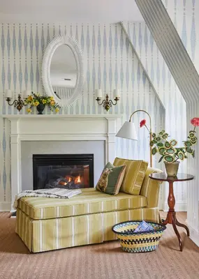 a living room with a couch and a fireplace at The Mayflower Inn & Spa, Auberge Collection in Washington