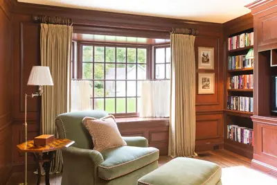 a living room with a chair and a window at The Mayflower Inn & Spa, Auberge Collection in Washington