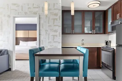 a kitchen and dining room with a table and chairs at Residence Inn by Marriott The Bronx at Metro Center Atrium in Bronx