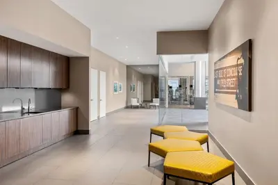a lobby with yellow stools in a building at Residence Inn by Marriott The Bronx at Metro Center Atrium in Bronx