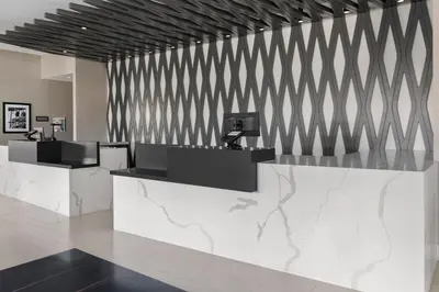 a restaurant with a counter with a black and white wall at Residence Inn by Marriott The Bronx at Metro Center Atrium in Bronx