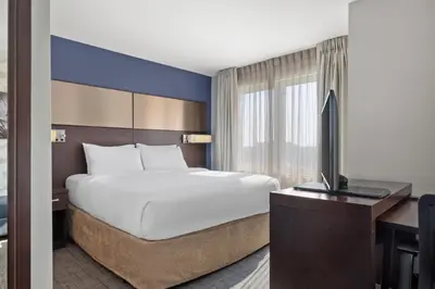a hotel room with a bed and a television at Residence Inn by Marriott The Bronx at Metro Center Atrium in Bronx