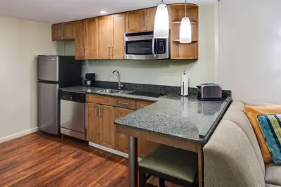 a kitchen with a counter and a sink and a microwave at Hyatt House Hartford North/Windsor in Windsor