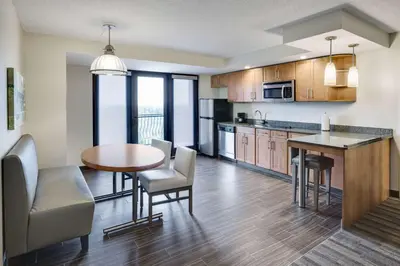 an open kitchen and dining room with a table and chairs at Hyatt House Hartford North/Windsor in Windsor