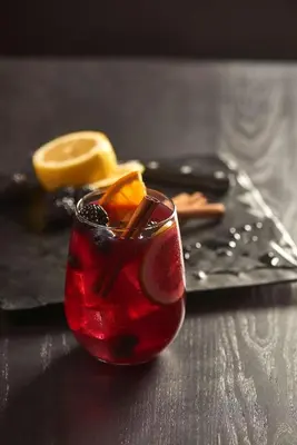 a red drink with orange slices on a table at Hyatt House Hartford North/Windsor in Windsor