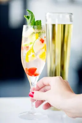 a hand holding a glass with a drink at Hyatt House Hartford North/Windsor in Windsor