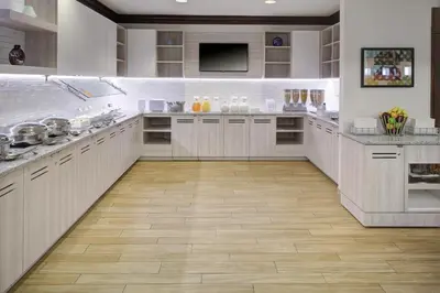 a large kitchen with white cabinets and a wooden floor at Hyatt House Parsippany Whippany in Whippany