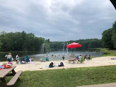 a group of people on a beach with a fountain at My Little Flagship Cabin in East Stroudsburg