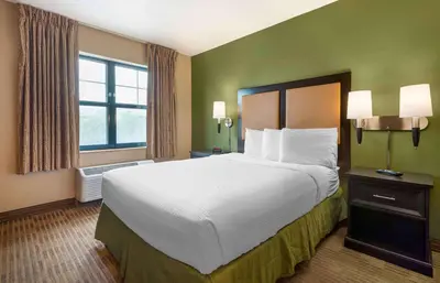 a hotel room with a large bed and a window at Extended Stay America Suites - Secaucus - Meadowlands in Secaucus