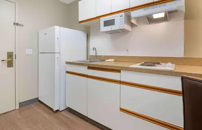 a kitchen with white cabinets and a white refrigerator at Extended Stay America Suites - Hanover - Parsippany in Whippany