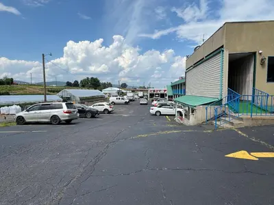 a parking lot with cars parked next to a building at Rodeway Inn Dunmore in Dunmore
