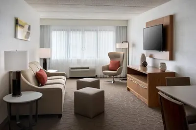 a large hotel room with a living room at Delta Hotels by Marriott Utica in Utica