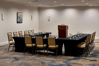 a conference room with a long table and chairs at Delta Hotels by Marriott Utica in Utica