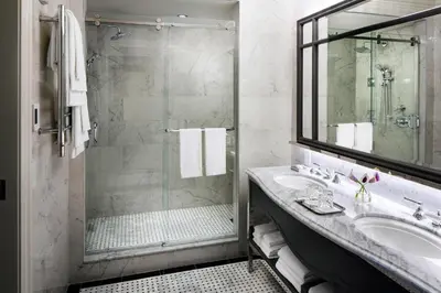a bathroom with a sink and a shower at The Adelphi Hotel in Saratoga Springs