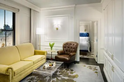 a living room with a couch and a chair at The Adelphi Hotel in Saratoga Springs