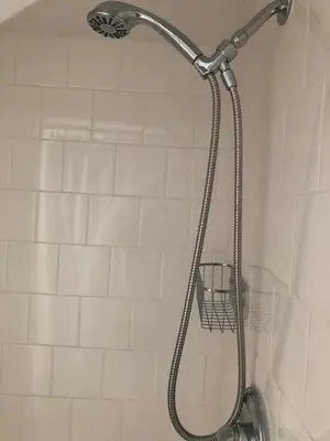 a shower with a shower head in a bathroom at Cozy Garden Apartment Along the Shoreline in Guilford