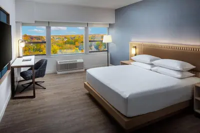 a bedroom with a bed and a desk and a window at Hyatt Regency Morristown in Morristown