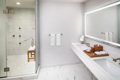 a white bathroom with a sink and a shower at Hyatt Regency Morristown in Morristown