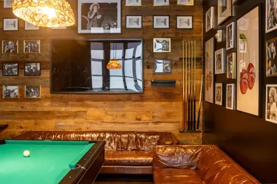 a billiard room with a couch and a pool table at Pod 39 in New York